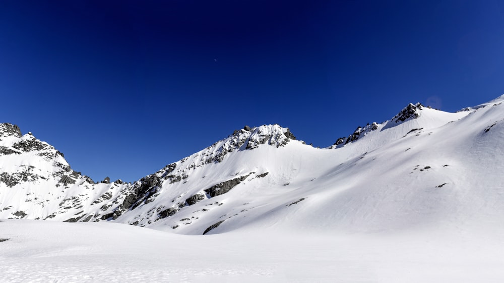 Montagna coperta di neve sotto il cielo blu