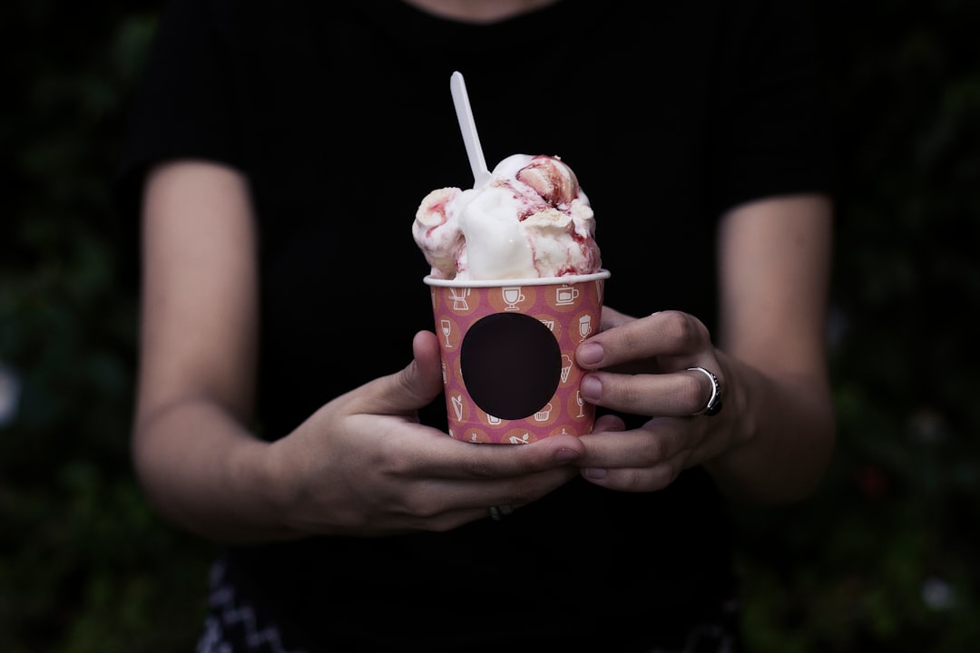 person holding bucket of ice cream