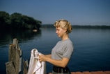 Women sharing a quiet moment of reflection on a peaceful lakeside dock.