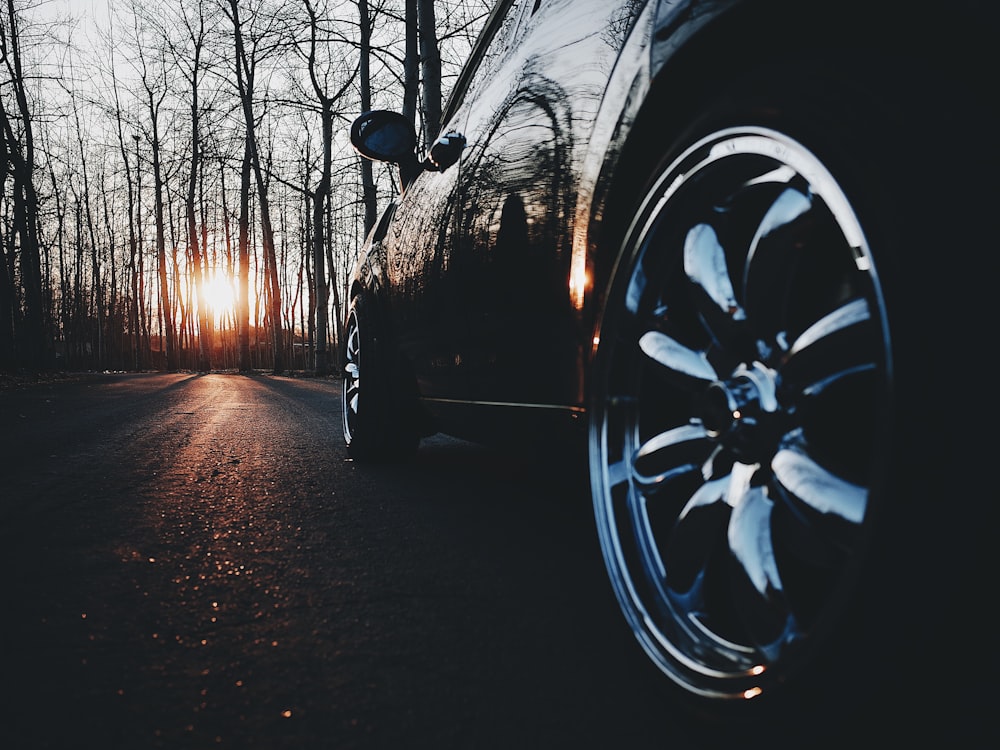 black car in the middle of the road during nightfall