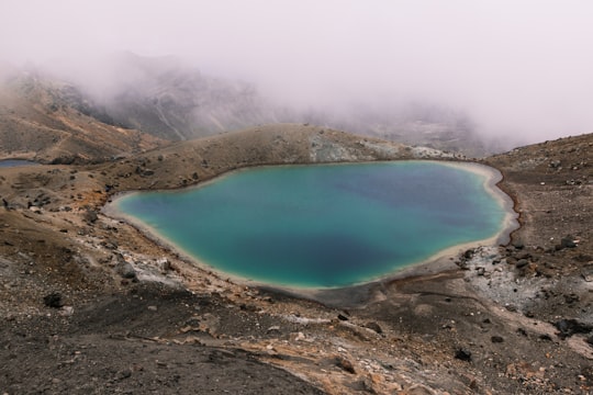 lake in the middle of mountain in Tongariro Alpine Crossing New Zealand