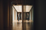 man walking towards opened door