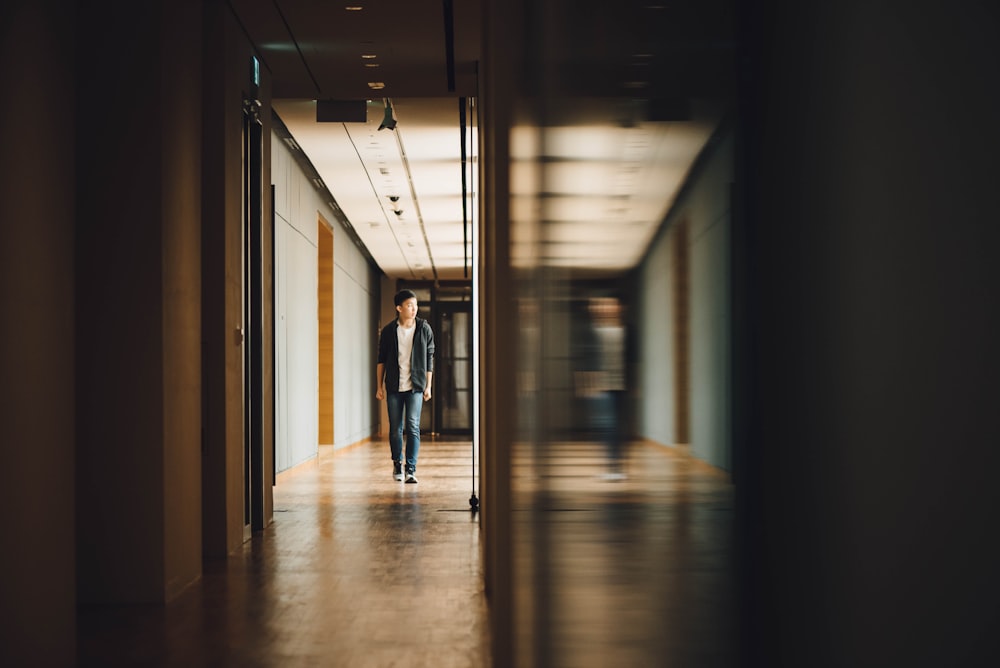 man walking towards opened door