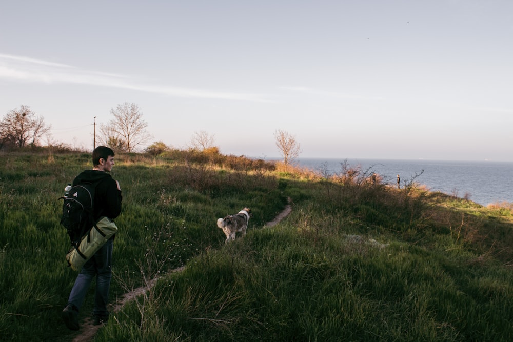 man walking on pathway nearby sea