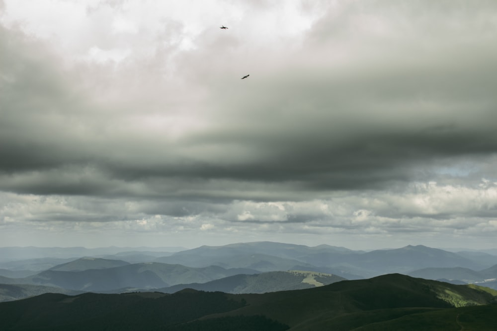 green hills under cloudy sky