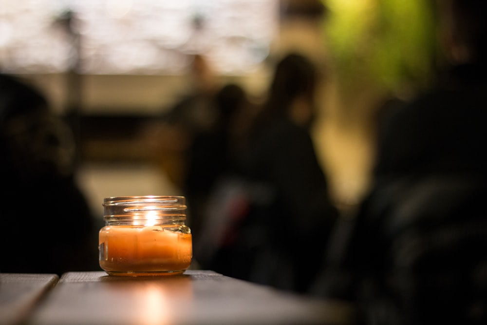 selective focus photo of votive candle