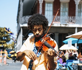 A man playing the violin or fiddle on the streets in New Orleans in the French Quarter