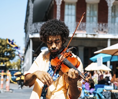 A man playing the violin or fiddle on the streets in New Orleans in the French Quarter