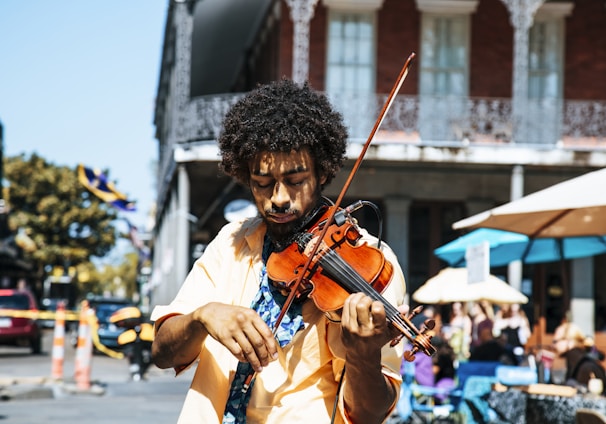 A man playing the violin or fiddle on the streets in New Orleans in the French Quarter