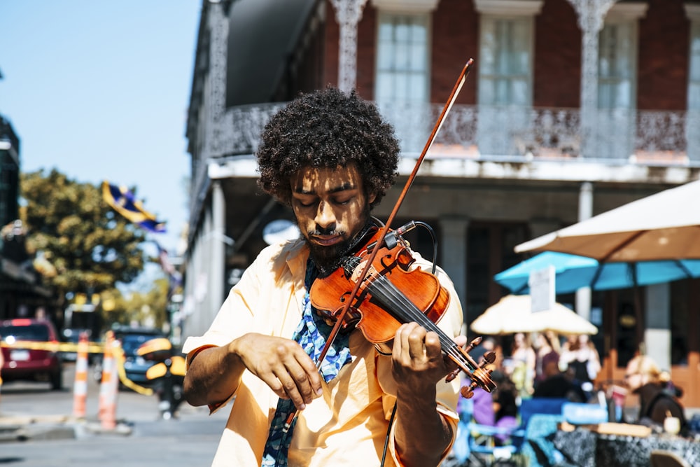 A man playing the violin or fiddle on the streets in New Orleans in the French Quarter