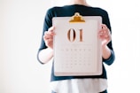 person holding calendar at January