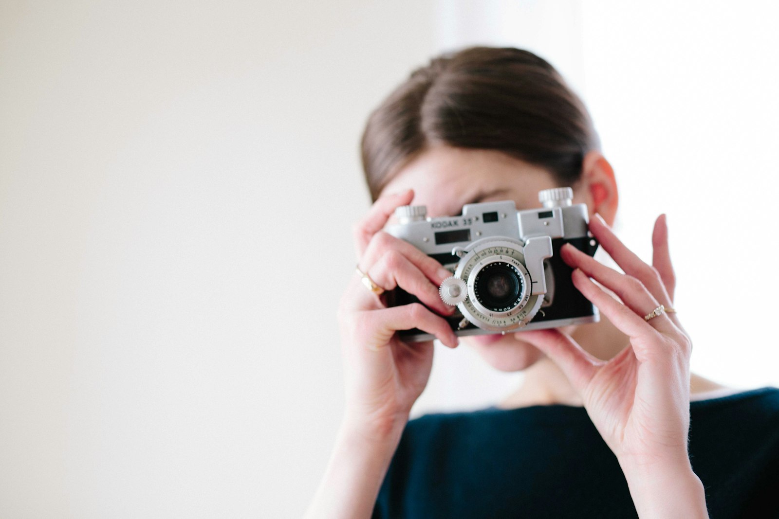 ZEISS Milvus 50mm F1.4 sample photo. Woman using camera taking photography