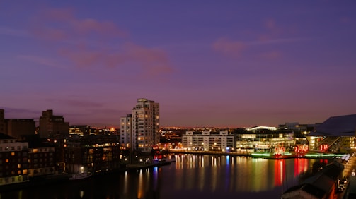 A twilight cityscape with twinkling lights showcasing a charming hotel facade.