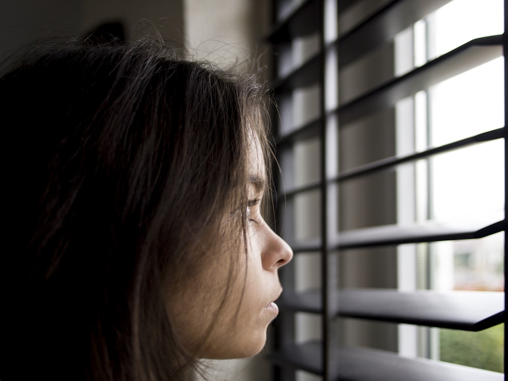 woman facing in front of window