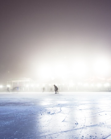 An empty indoor ice rink with fresh ice and rink boards, similar to the Hylo Park Ice Arena in North Las Vegas