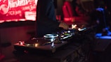 person using DJ controller while standing