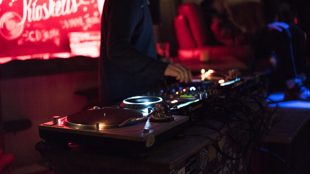 person using DJ controller while standing