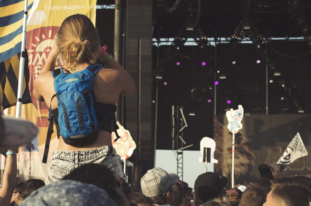 woman carrying blue and black hydration pack