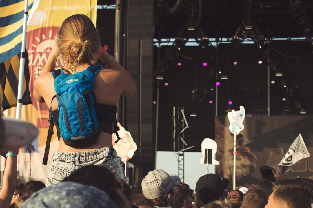 woman carrying blue and black hydration pack