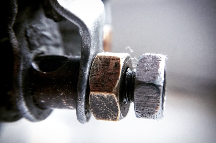 Close-up of a heavy-duty steel fastener used in construction machinery.