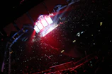 Wide shot of the venue filled with people enjoying the music and lights