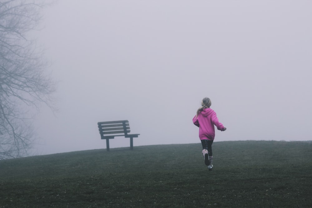 girl running near black bench