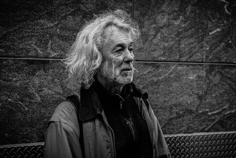 grayscale photo of long-haired man