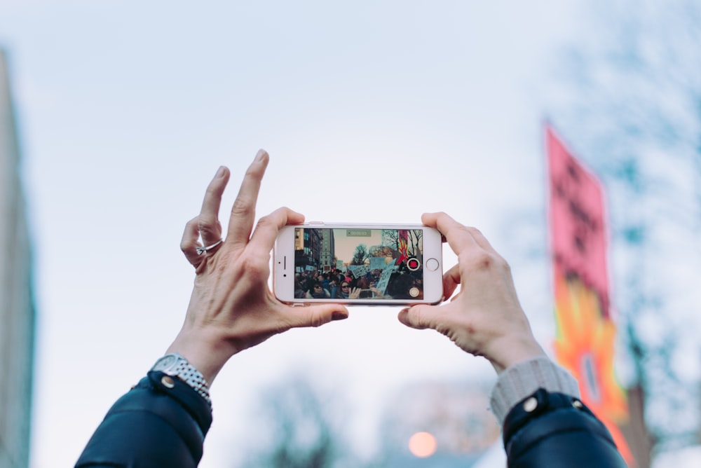 person taking photo using iPhone 6 during daytime