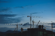 several cranes above the buildings
