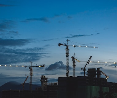 several cranes above the buildings