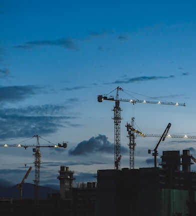 several cranes above the buildings