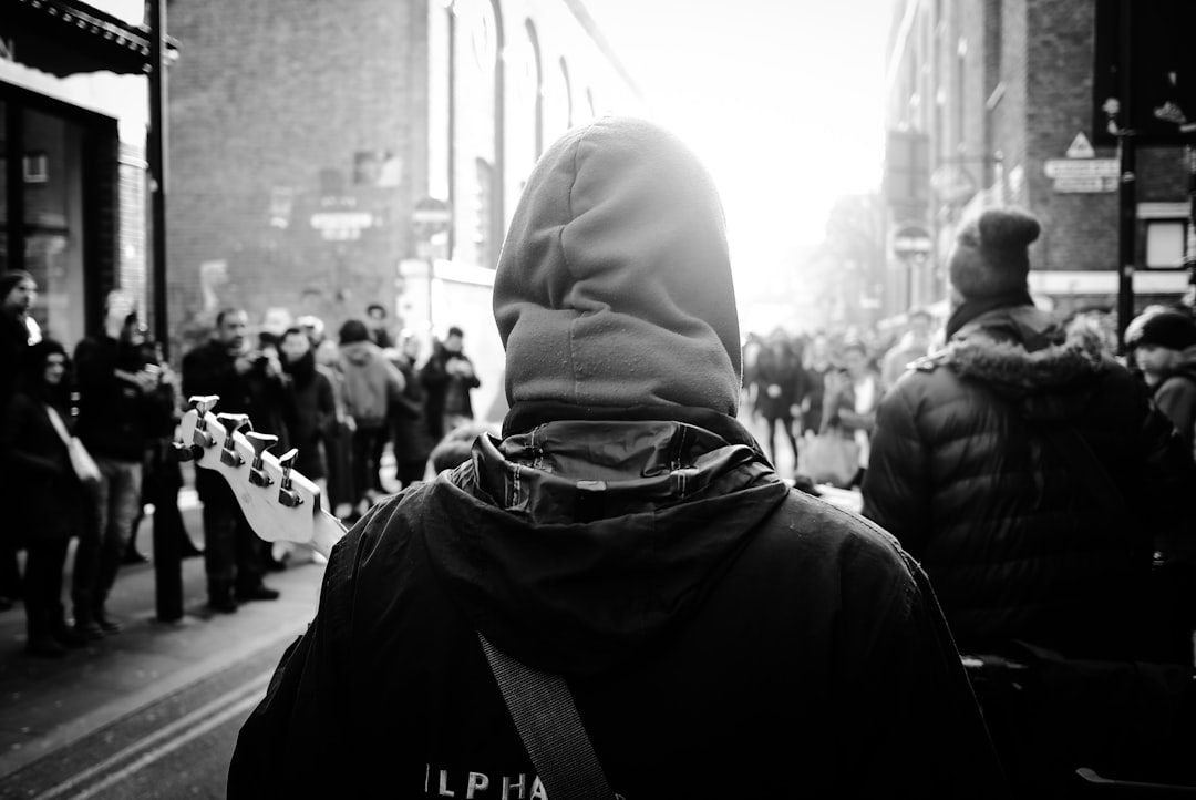 grayscale photography of person wearing hoodie