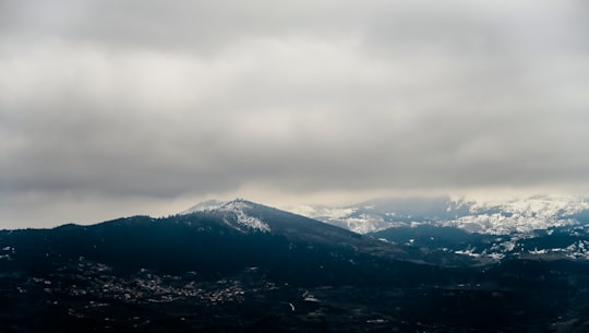 black rocky mountain under white cloudy sky during daytime in Ano Trikala Greece