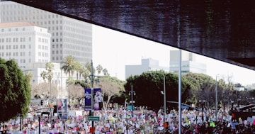 crowd of people near concrete buildings during daytime