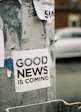 white Good News Is Coming paper on wall