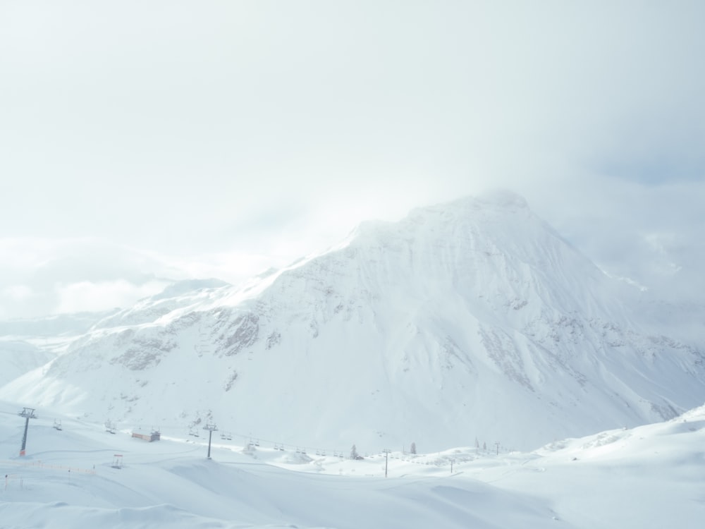 white mountain filled with snow under white sky