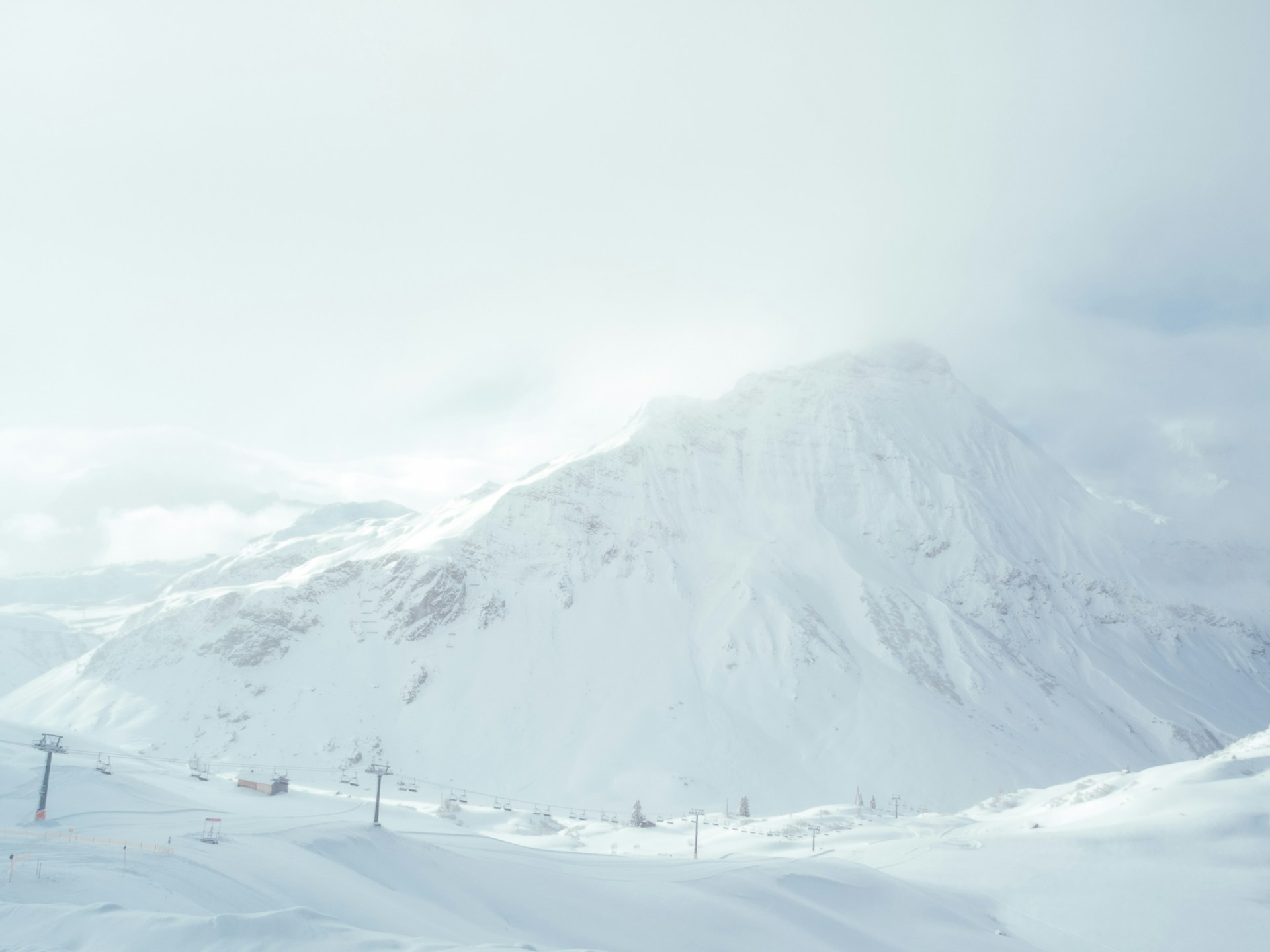 white mountain filled with snow under white sky