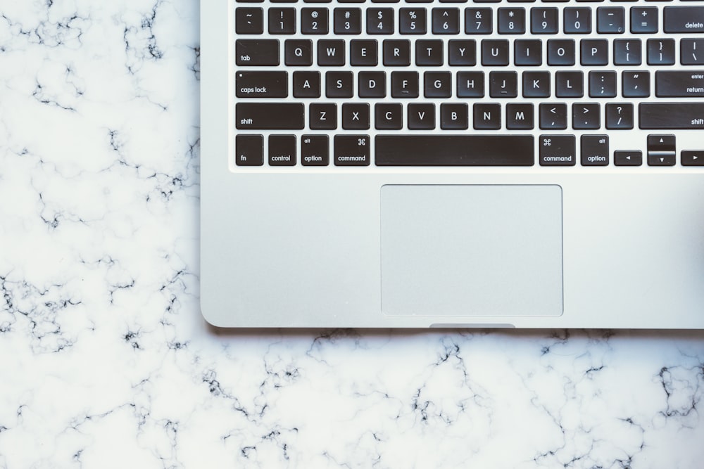 MacBook Pro on white marble surface