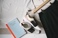 pair of white-and-black low-top sneakers near black skirt on brown clothes hanger top view photography