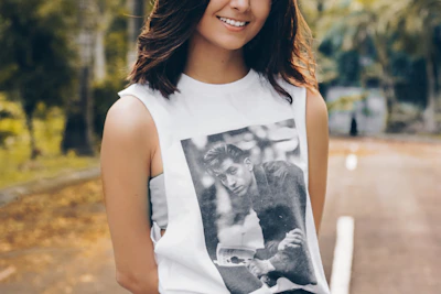 Smiling customer wearing a Direwolf Prints t-shirt outdoors.