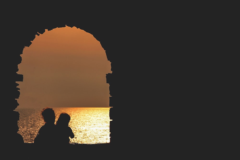 silhouette on building facing sea