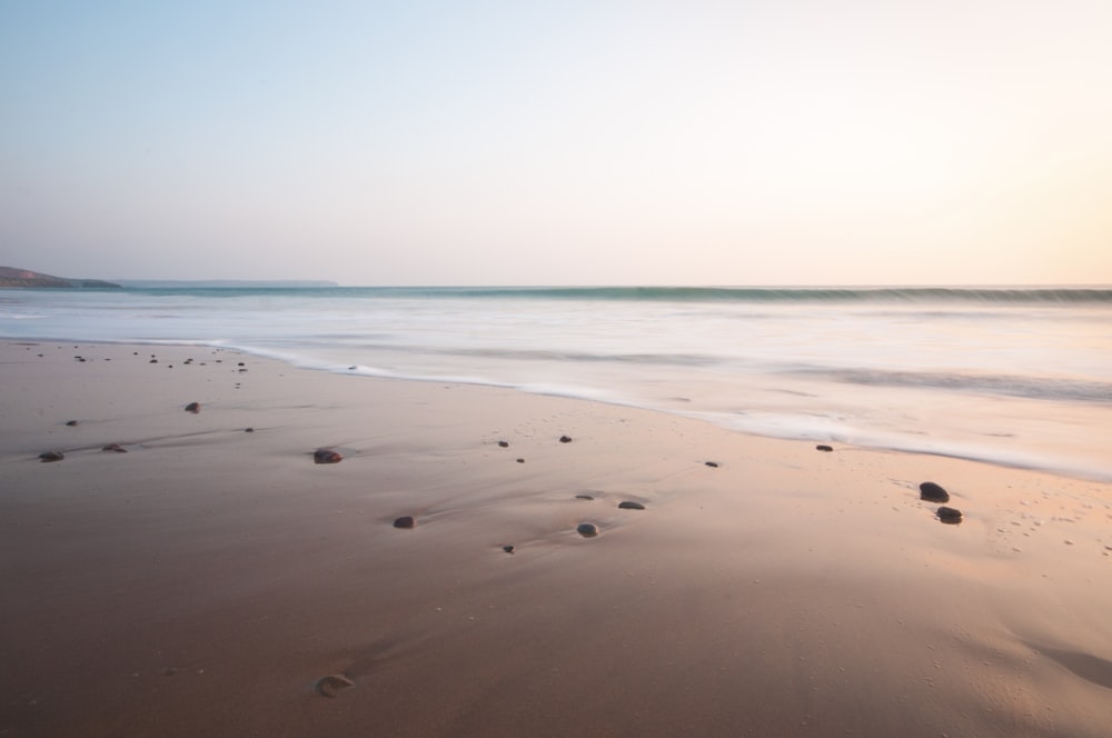 photo of seashore under gray sky