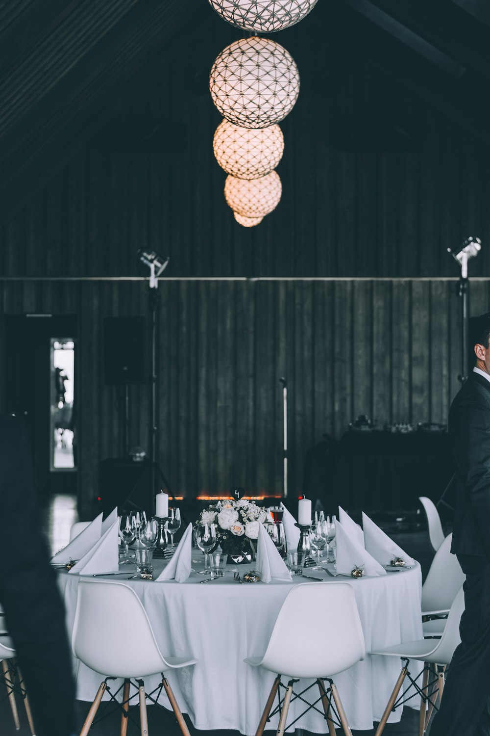 set da pranzo rotondo bianco e marrone con lampade a sospensione a sfera fotografia