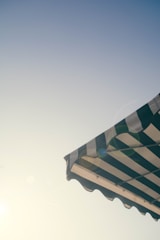 A professional installation of custom awnings in a sunny Marbella setting.