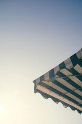 Wide shot of colorful and sturdy outdoor awnings providing shade.