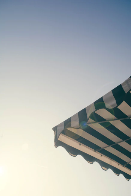 Retractable awning extended over a commercial storefront on a sunny day