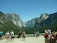 A group of travelers enjoying a scenic viewpoint overlooking a lush green valley.