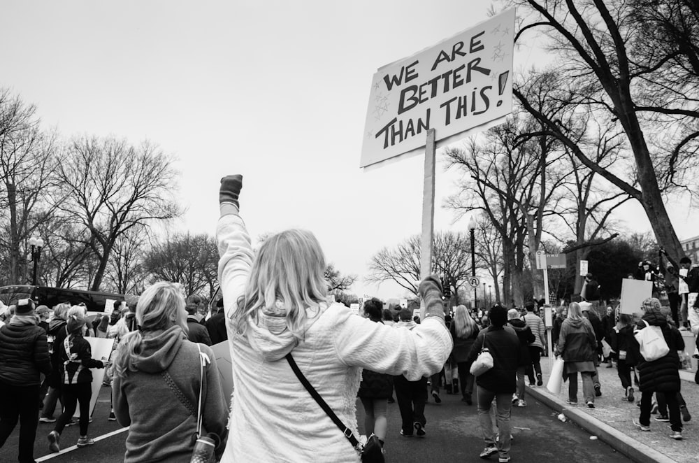 Black and white photograph of the back view of street protesters in a rally in Washington.