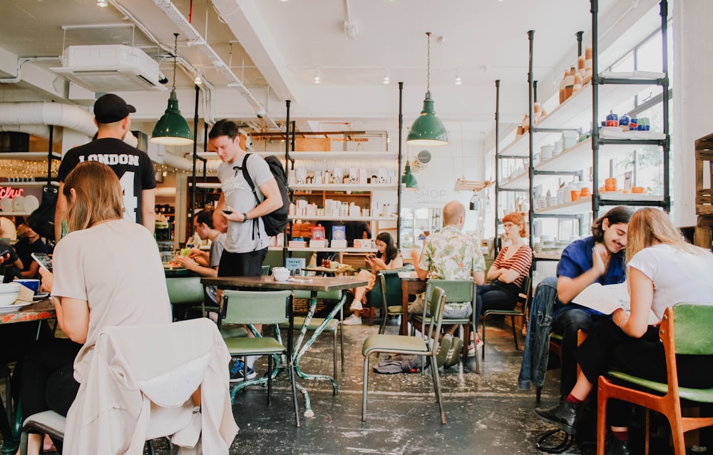 Young people working and socializing at a busy coffee shop