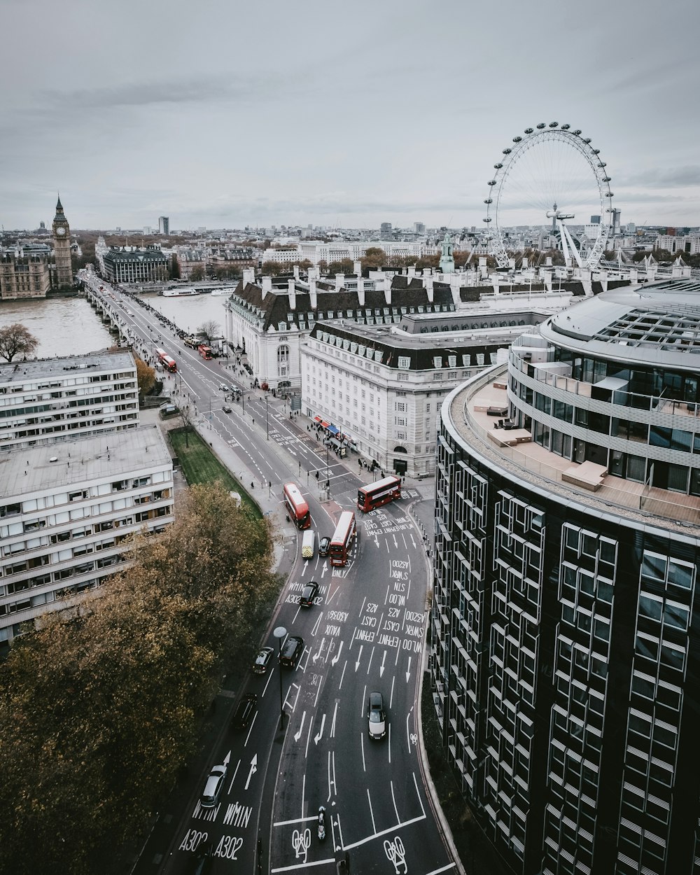 high angle photography of vehicles passing on street surrounded with city buildings